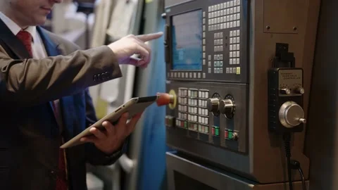 Chief Engineer Use Tablet in Modern Factory, control CNC Machinery Stock Footage 152509020