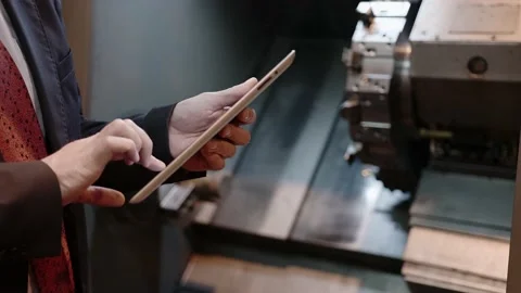 Chief Engineer Use Tablet in Modern Factory, control CNC Machinery Stock Footage 152509030
