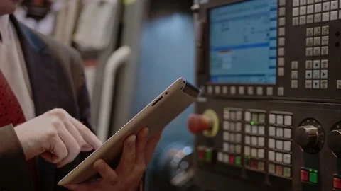 Chief Engineer Use Tablet in Modern Factory, control CNC Machinery Stock Footage 152562225
