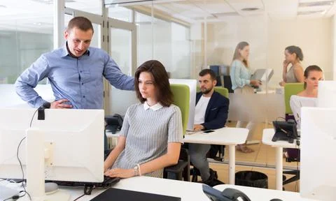 Chief executive explaining task to female Stock Photos