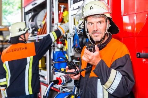 Chief fire fighter  checking radio set Stock Photos