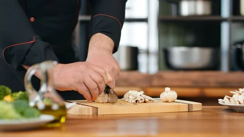 Chief hands cutting mushroom on slice use knife. Close up shot on 4k RED camera Stock Footage 124157347