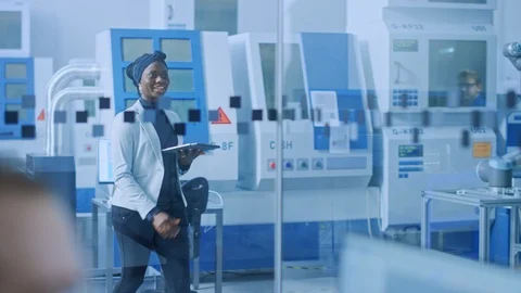 Chief Industrial Engineer Walks Through Factory, She Uses Tablet Computer Video stock 123634969