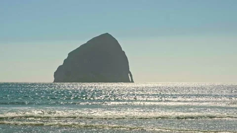 Chief Kiawanda Rock sea stack standing in the glittering ocean water at Pacif-73 Stock Footage 345392489