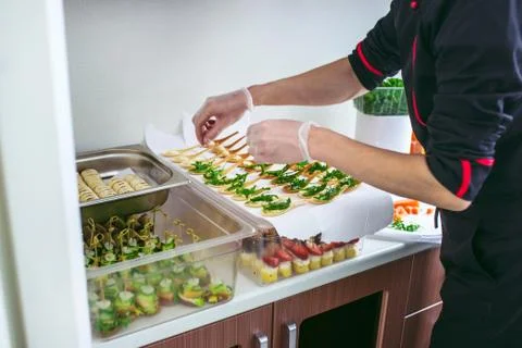 Chief at kitchen prepareing delicates, appetizers. Catring service. Closeup Stock Photos