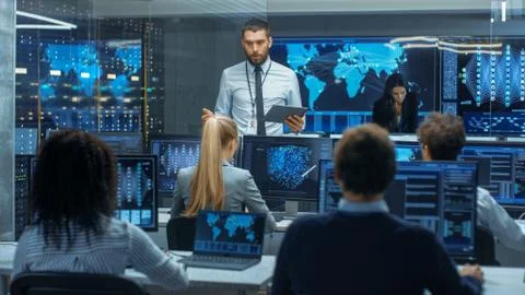 Chief Project Engineer Holds Briefing for a Team of Scientists that are Build Stock Photos
