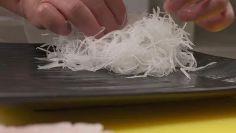 Chief is putting grated daikon on square plate Stock Footage 213466260