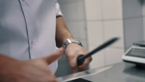 Chief sharpens a knife in the kitchen Stock Footage 112587021