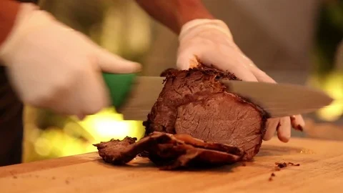 Chief slicing roasted piece of meat. Steak. Video stock 74494288