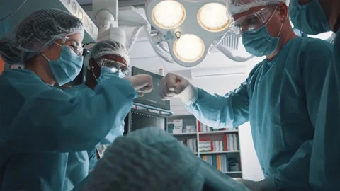 Chief surgeon and team bumping with fists after succeeding surgery patient lung Stock Footage 144854826