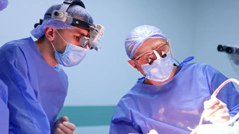 Chief surgeon leaned to the side performing operation. Modern neurosurgery in Video stock 333337037