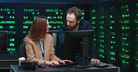 Chief system administrator communicates with female junior programmer by Stock Footage 145295806