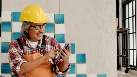 Chief technician is using the smartphone to order online. Video stock 112290969