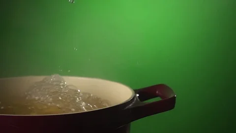 Chief is throwing pasta in a pot of boiling water, fullhd slow motion video Stock Footage 71620701