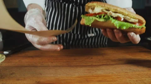 Chief Turns to the Wrapper Big Sandwich Vídeo Stock 64688537