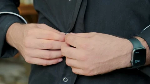 The chief is unbuttoning his uniform. Stock Footage 233065974