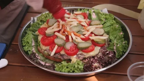 Chief using sause while assembling huge burger. Stock Footage 79284997