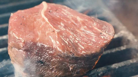 Chief using the spatula and turning the meat on the grill 動画素材 107532448