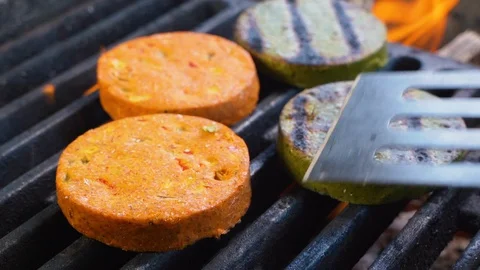 Chief using the spatula and turning vegetable cutlets for Vegan Burger Stock-Footage 108350811