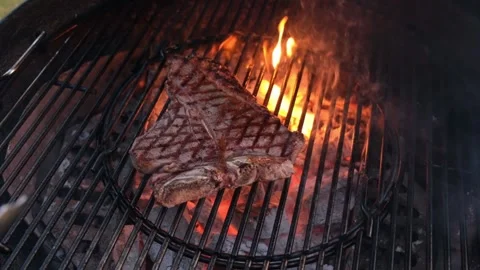Chief using the tong and turning the meat on the grill. Stock Footage 148081803