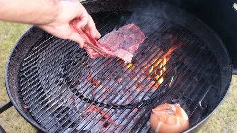 Chief using the tong and turning the meat on the grill. Stock-Footage 148082530