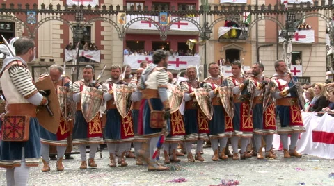 Chief of the warrior band performs dance in front of line with shields Stock Footage 47977455