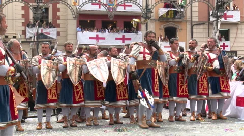 Chief of the warrior band performs dance in front of line with shields Stock Footage 47977538