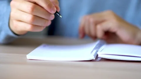Chield wrote yellow pen in a notebook. Close up view. Stock Footage 125638970