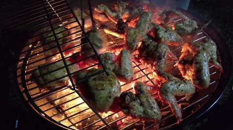 Chiken wings on grill in fire Stock Footage 66682911