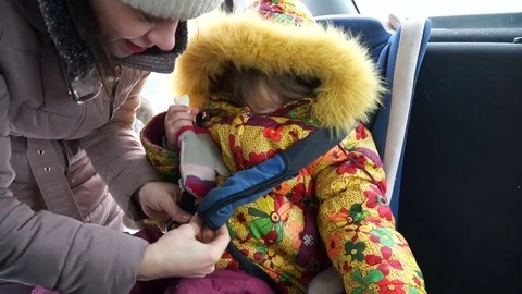 Child 4-5 years old sitting in the car child seat and eat something. Stock Footage 72760573