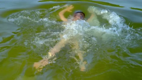 Child 9 years old, boy swims in lake, river, summer pond, concept of fun holi Video stock 171273597