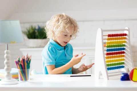 Child with abacus doing homework after school. Foto stock