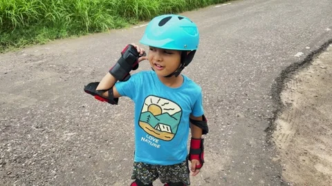 Child in action during Roller Skating With Helmet And Protective Pads Outdoors Vídeo Stock 347127936