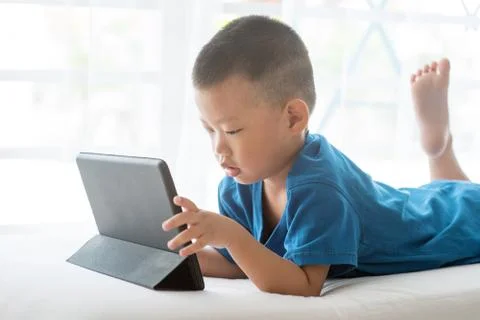 Child addicted to tablet. Stock Photos