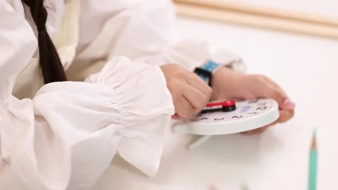 Child Adjusting Educational Clock During Hands-On Time Learning Activity Stock Footage 323777689