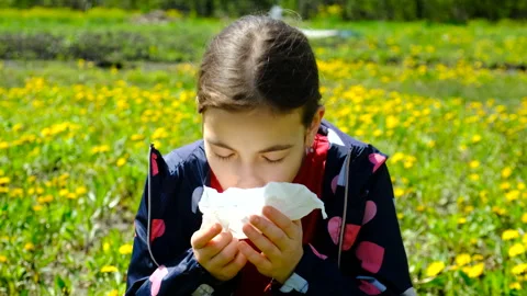 The child is allergic to flowers. Selective focus. Stock Footage 258677746