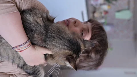 Child and cat. Close-up of fluffy cat in the arms of a child Stock Footage 151861002