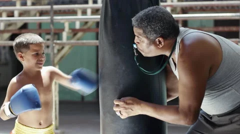 Child and hispanic trainer practicing in boxing gym sport fun Video stock 52796397