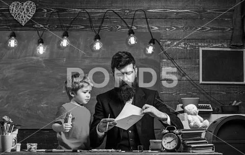 Child and teacher on busy face painting, drawing. Talented artist spend time Stock Photos