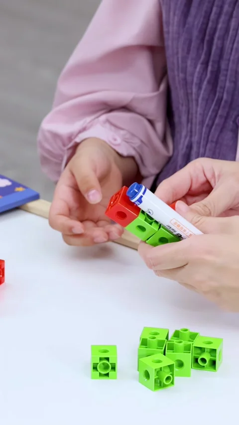 Child and Teacher Using Colorful Building Blocks Stock Footage 325697182