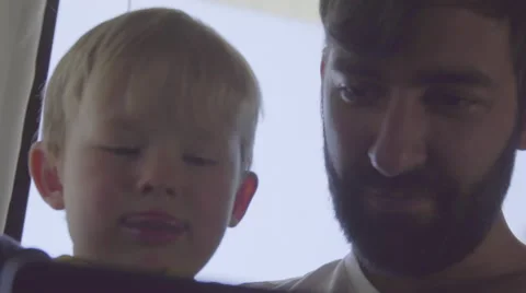 Child and uncle tap on mobile phone Stock Footage 64407172