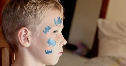 Child animator, artist's hand draws face painting to little boy. Stock Footage 202095553