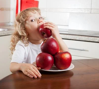 Child with apple Stock Photos