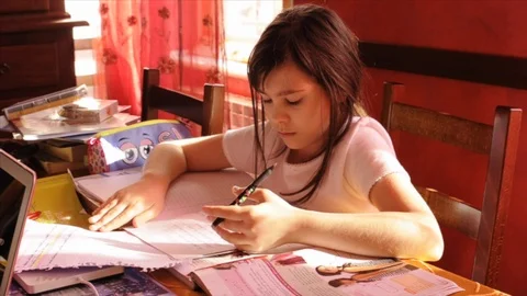 Child with Asperger's Syndrome has difficulty performing homework Stock Footage 87499904