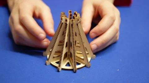 A child assembles a children's wooden constructor from individual elements Stock Footage 260354500