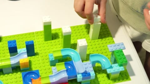 A child assembles a colorful Crazy Marble Run construction set. Close-up. Stock Footage 317917499