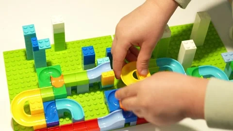 A child assembles a colorful Crazy Marble Run construction set. Close-up. Stock Footage 317917514