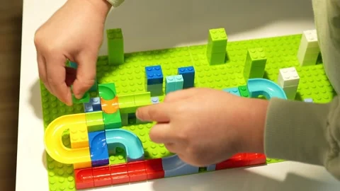 A child assembles a colorful Crazy Marble Run construction set. Close-up. Stock Footage 317917539