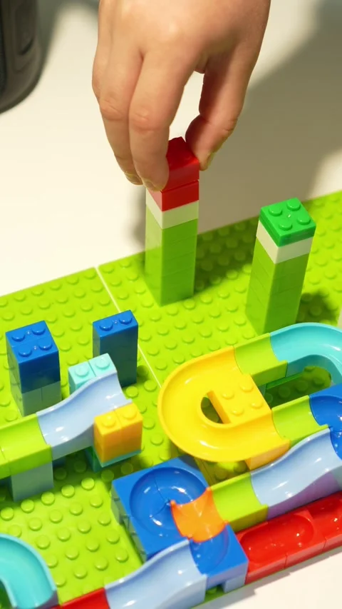 A child assembles a colorful Crazy Marble Run construction set. Close-up. Stock Footage 317918124