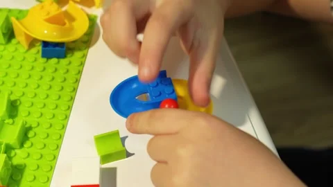 A child assembles a colorful Crazy Marble Run construction set. Close-up. Stock Footage 317918328